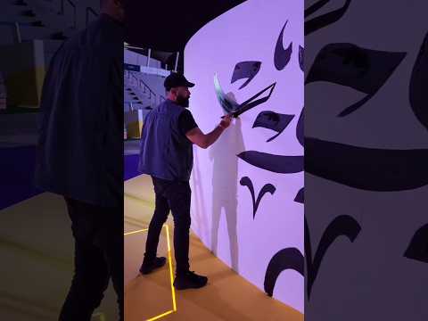 A live Arabic calligraphy mural created in front of visitors at Etihad Arena