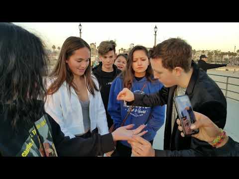 An x jumps from one person's hand to another by magic!